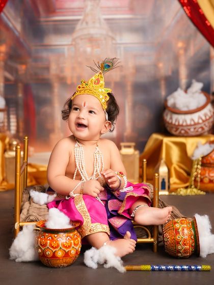 The joy and mischief of little Krishna captured perfectly. His happy expression and the traditional props make this a lively and delightful photograph.
