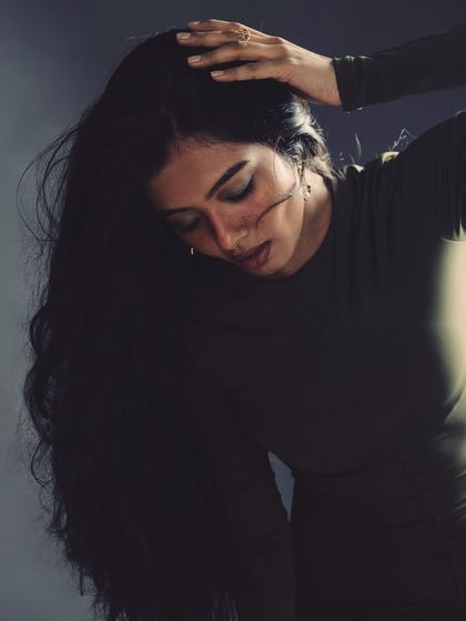 A moment of quiet introspection amidst the chaos of the wind machine. This shot captures the feeling of the hair in motion, with the model's downward gaze adding a touch of vulnerability to the powerful series.