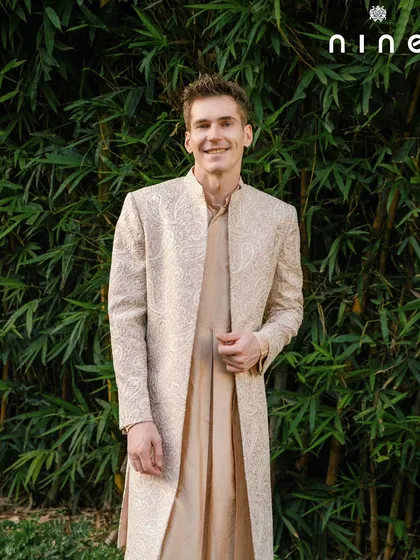 This open sherwani paired with a Choga kurta is my modern take on the old Mughal era. It's handcrafted for a graceful silhouette, perfect for a wedding or a grand festive occasion. The look is timeless, elegant, and exceptionally comfortable.