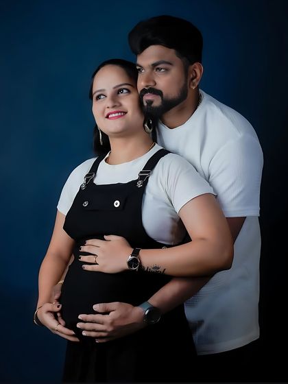 A confident and modern studio portrait. The partner stands behind, creating a sense of support and unity, while they both look towards the future.