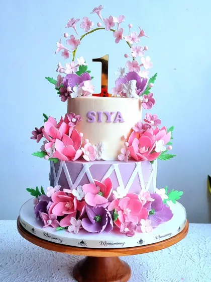 A full view of the pink and purple garden-themed cake.