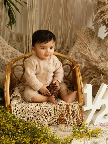 The half-birthday or sitter session is such a sweet milestone. At around six months, they are sitting up, full of expressions, and so curious about the world. This boho-chic setup with natural textures was perfect for capturing this baby's calm and gentle spirit.