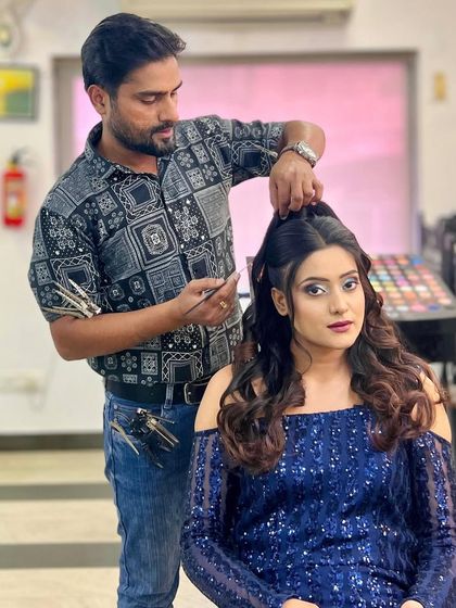 An instructor demonstrates how to create a voluminous, half-up hairstyle with soft curls, a popular choice for receptions and parties.