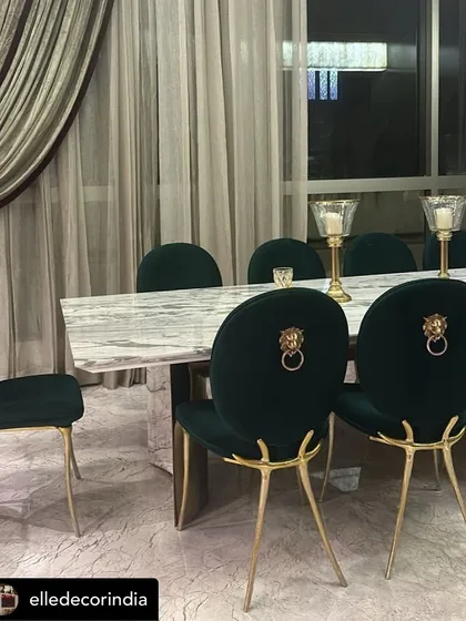 A statement in luxury dining. These custom emerald green velvet chairs feature bold lion head knockers and sculptural gold legs, paired with a substantial marble-topped table. This set was created to be the centerpiece of a grand dining space, reflecting our commitment to opulent and personalized design.