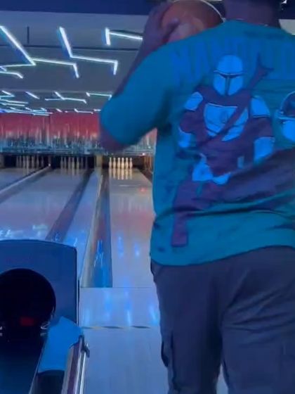 A glimpse from our bowling league, with a player in a Mandalorian t-shirt getting ready to bowl.