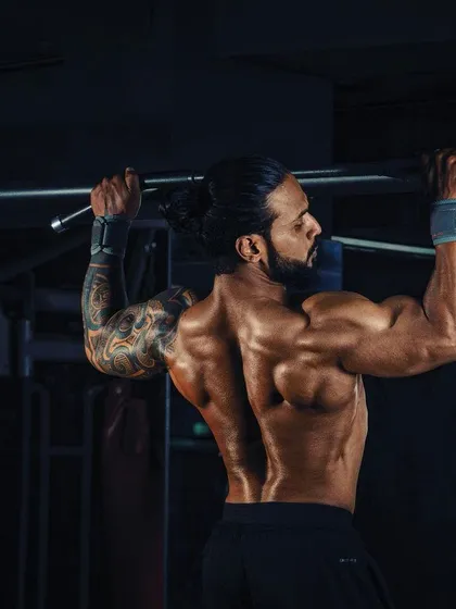 A strong back is the foundation of a powerful physique. My training programs include targeted exercises like pull-ups to build width and thickness, improving both your posture and overall strength.