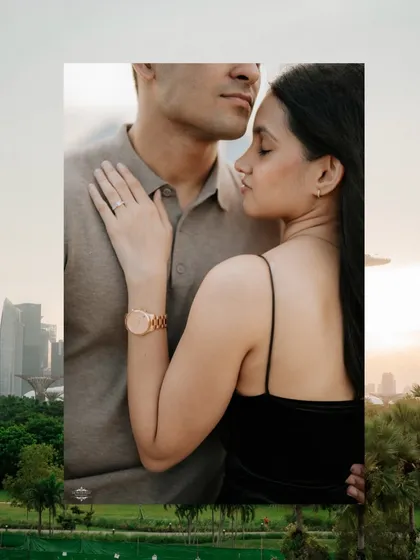 An intimate close-up with the Singapore skyline in the background. This shot highlights personal details like the engagement ring and watch, adding another layer to the story.