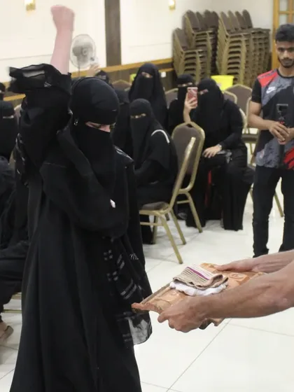 A woman who can raise her voice for herself becomes an inspiration for thousands of others. Here, a participant practices breaking a brick, a powerful symbol of breaking through personal barriers.