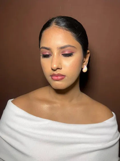 A clean, polished look for the brand Andham. The makeup features a subtle pink eyeshadow and a neat, defined brow, perfect for a commercial beauty shoot.