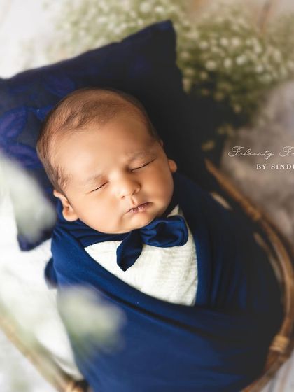 A different angle of our little gentleman, showing the full setup with a basket and soft white flowers. Each pose is carefully considered for both beauty and safety.