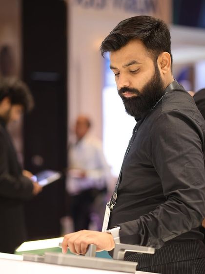 An attendee tests the functionality of a minimalist smart control interface, highlighting the focus on user-centric design and simplicity in modern automation.
