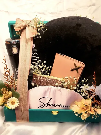 A gift hamper filled with surprises and customized gifts for your favorite girl. This travel-themed hamper includes a personalized neck pillow, passport cover, and tumbler.