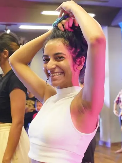 A student beaming with joy during an intensive class.