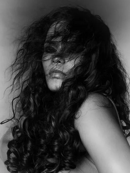 A softer, more mysterious shot from the same series. The hair partially obscures the face, drawing the viewer in and adding to the moody, artistic feel.