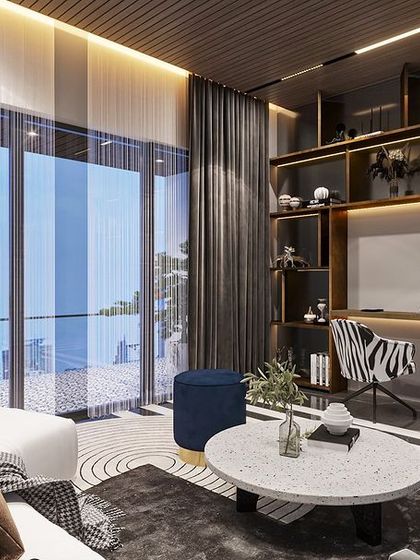 The same living area includes a functional study nook with an integrated desk and backlit shelving, showing how we blend work and leisure spaces seamlessly.