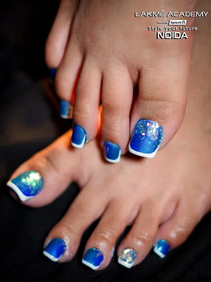 A close-up view of the big toe, showcasing the intricate glitter and pattern work. This demonstrates the precision and attention to detail we instill in our students during their pedicure training.