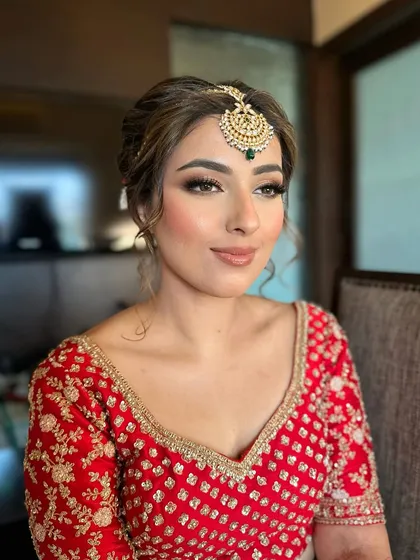 Jasmeet's dream look for her wedding. A classic red blouse paired with a bronze smokey eye and a warm nude lip for a sophisticated bridal style.