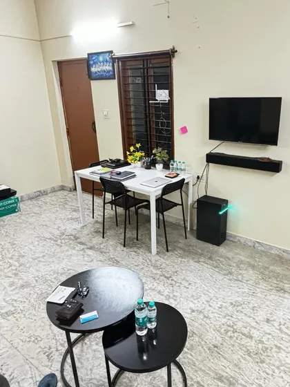 A wider shot of the Bangalore office living space, showing the blend of a startup environment with professional essentials.