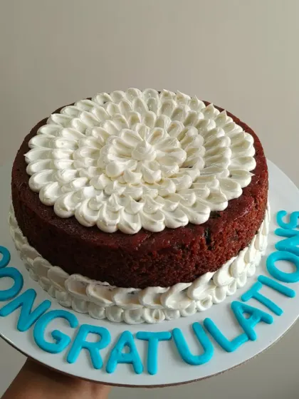 My rich fruit cake isn't just for Christmas. Here, I've decorated it with buttercream frosting and a "Congratulations" message for a special occasion.