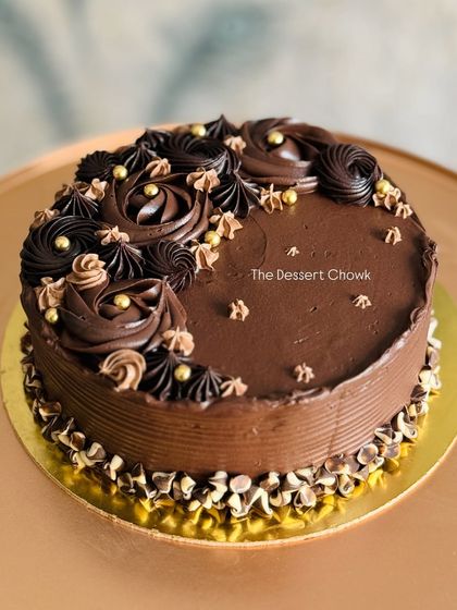 This Mocha Chocolate cake is a treat for coffee and chocolate lovers. The rich chocolate cake is frosted with a smooth coffee ganache and decorated with intricate piping work.