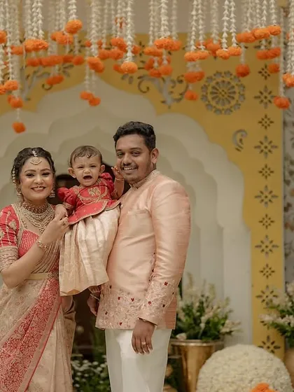 There is nothing more special than dressing the entire family. Here, we created a coordinated set in peach and red for a naming ceremony, ensuring the parents and their little one looked picture-perfect for their milestone celebration.