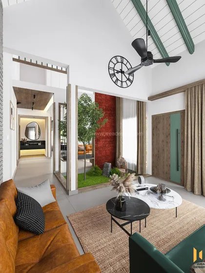 A view of the family living area on the upper level of the duplex, featuring a vaulted ceiling and a mix of green and tan sofas.