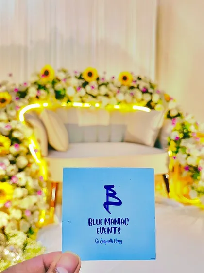 A fun shot holding my business card in front of the completed floral couch decor. It's a testament to the pride I take in my work and the beautiful results I deliver.