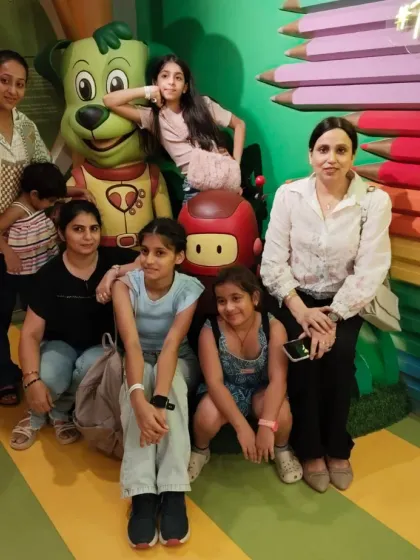 A group of friends and family gathers for a picture with our Tinga Dojo statue, a popular photo spot.