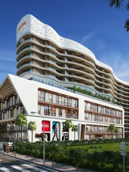 The daytime view of our Tropicano project in Guwahati showcases the building's distinctive wavy facade. This mixed-use design combines retail at the base with residential towers that appear to ripple against the sky.