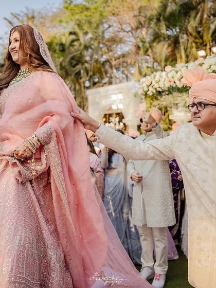 The father of the bride proudly walking his daughter down the aisle.