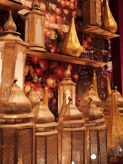 A close-up of the lamp market, where dozens of brass Moroccan-style lanterns were displayed against a floral-printed backdrop, creating a magical, glowing effect.