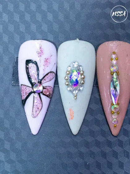 A simple yet elegant set created by one of our students. This showcases their skill in glitter application, line work, and creating stunning focal points with large rhinestones.
