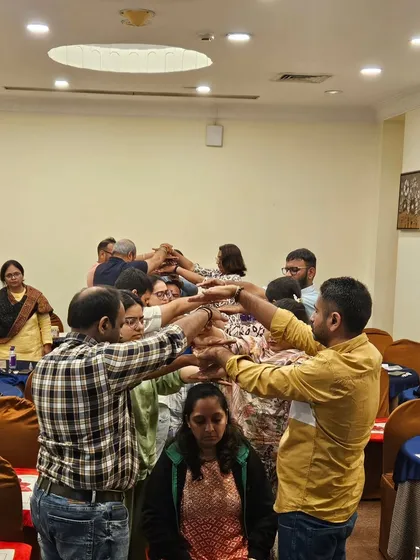 A powerful group healing exercise in progress. Participants channel positive energy to one person, demonstrating the principles of collective healing and intention.