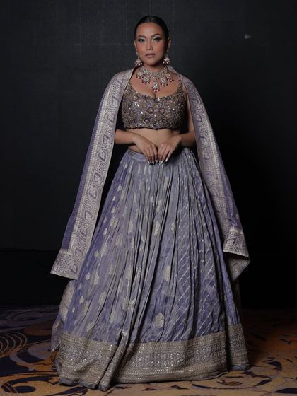 A full-length view of the model in the lavender-grey lehenga and rental jewellery.