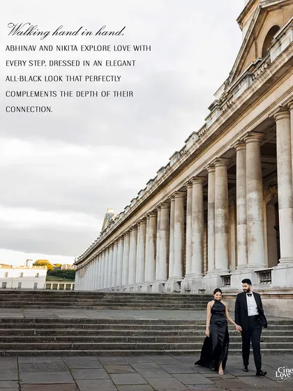 An expansive shot showing the couple against the grand scale of London's architecture. Their elegant black outfits provide a beautiful focal point in the grand setting.