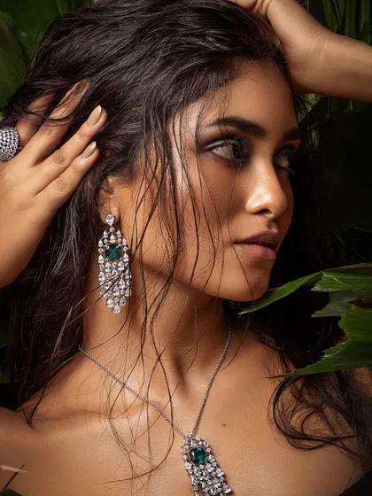 Another angle from the jungle-themed shoot, focusing on the stunning diamond and emerald earrings.