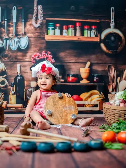 Holding up the chopping board with pride. These action shots are great for capturing the developing motor skills and playful nature of babies around the 9-month milestone.