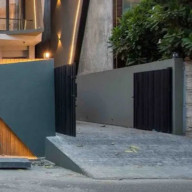 The gate and driveway entrance for Casa Acentuada, continuing the theme of angular, dynamic forms.