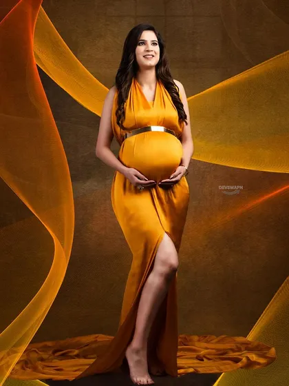 A modern and artistic portrait using light trails to frame the subject. The client stands confidently in a beautiful mustard gown, creating a unique and contemporary image.