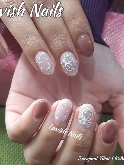 A delicate, winter-themed design with hand-painted white stars and a geometric pattern on a sheer, shimmery base.