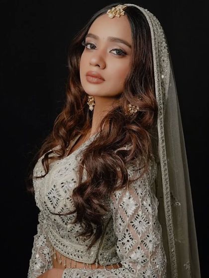 A full view of the elegant maang tikka and jhumka set, paired with a white chikankari lehenga. This jewellery is available for rent.