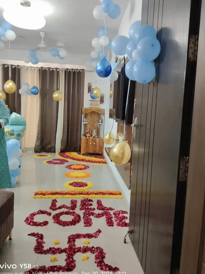 A wide view of the hallway decorated with balloons and flower petals to welcome the new baby home.