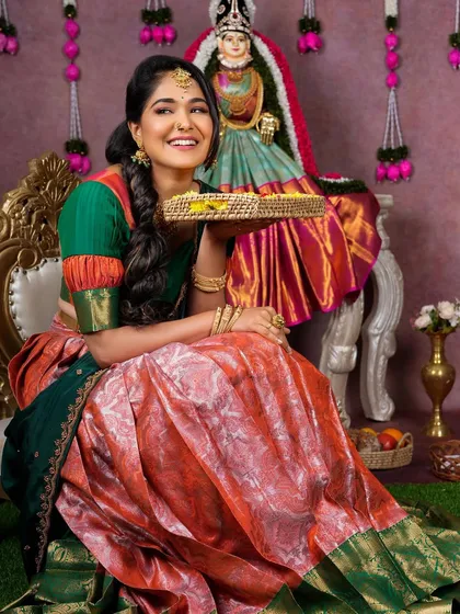 A joyful model in a traditional half saree for a Varamahalakshmi festival theme, wearing our simple gold-finish choker and jhumkas.