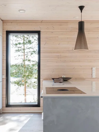 The Secto 4201 pendant in black laminated birch over a kitchen island. The craftsmanship is evident in the way the individual slats are connected by rings of aircraft plywood.