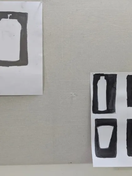 A close-up of student work pinned to the wall. These exercises in positive and negative space are crucial for developing a good sense of composition.