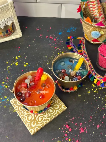 Add a splash of color to your Holi celebrations with my special 'balti' candle, complete with tiny wax water balloons and a pichkari.