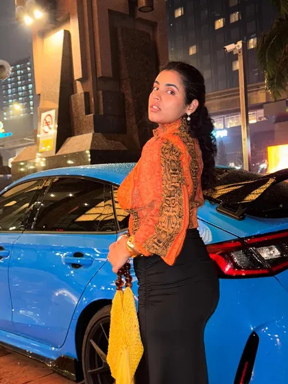 Two big boy toys, both in their prime. Posing with a cool car in my thrifted orange top. Your outfit should always match the energy of your surroundings.