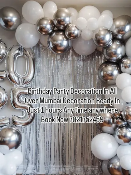 A sleek and modern silver and white balloon decoration. The foil numbers can be customized for any birthday or anniversary year, and the silver shimmer curtain adds a touch of glam.