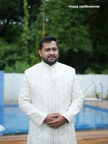 Our client looking confident in the off-white rental sherwani. It's a timeless piece that is suitable for both day and night wedding functions.