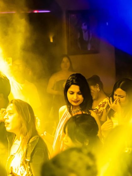 The dance floor enveloped in a yellow haze from the party lights. The lighting and effects are a crucial part of the immersive experience I create.